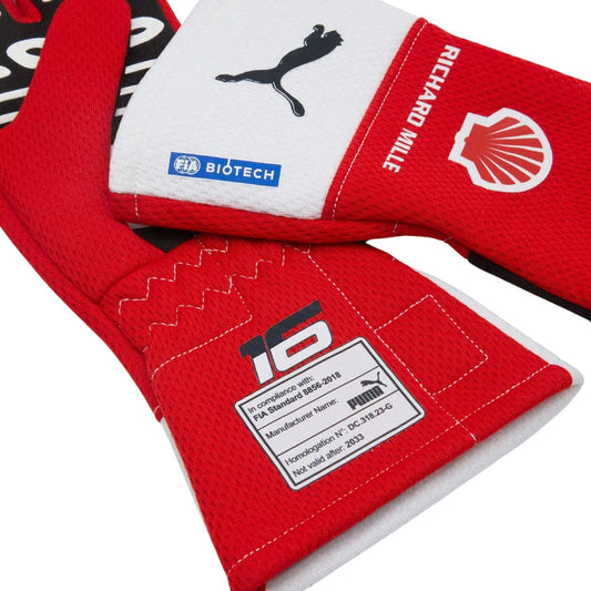 Red and white Charles Leclerc F1 race gloves with various logos on a white background