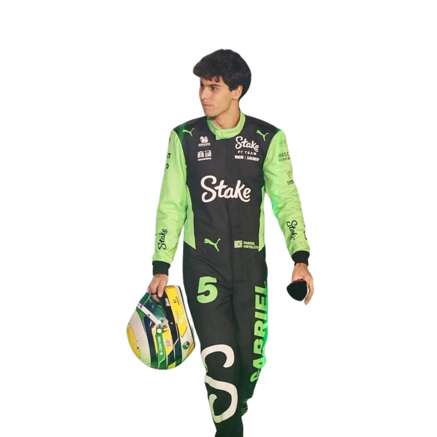 Gabriel Bortoleto walking in the pit lane holding helmet during the 2025 season in his full F1 suit, ready for race action.