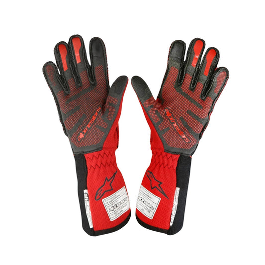 Pair of red and black Romain Grosjean 2023 IndyCar Race gloves on a white background