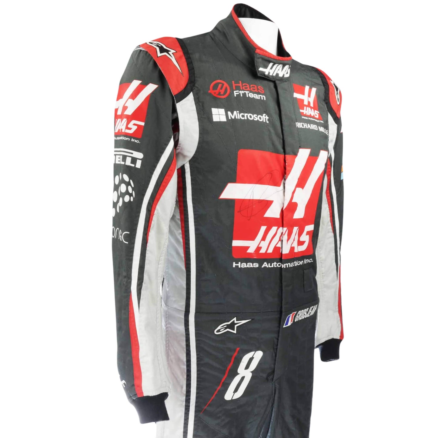 Left side view of Romain Grosjean’s 2017 racing suit, showcasing embroidered sponsor logos and precision craftsmanship for performance racing.