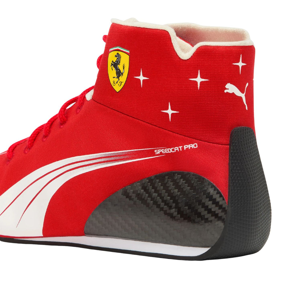 A close-up side view of a Puma x Ferrari Speedcat Pro high-top sneaker. The shoe features a vibrant red upper with white graphic stripes, a yellow Ferrari shield logo on the ankle, white star accents, and a black carbon-fiber-look heel section.
