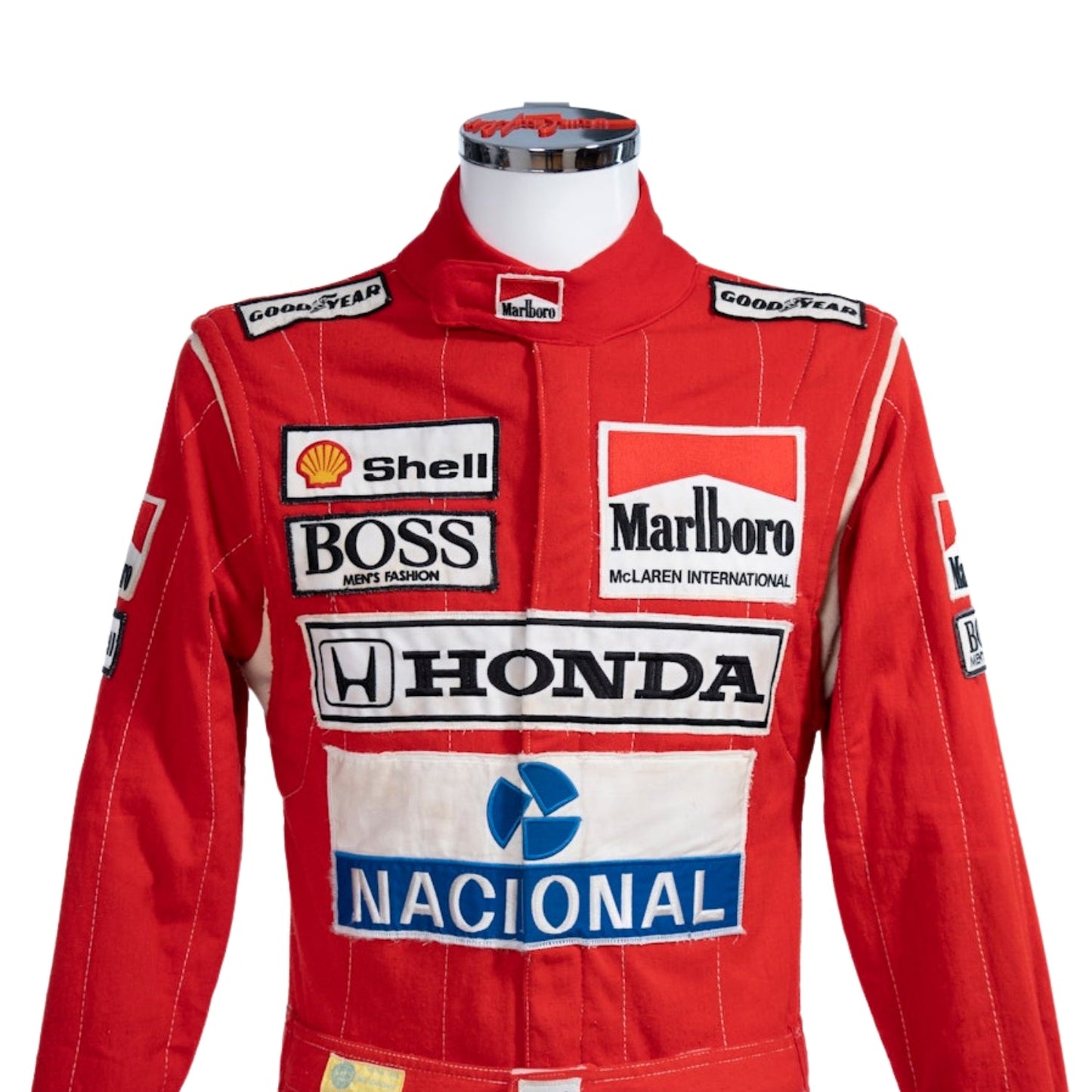 Ayrton Senna 1988 Mclaren Stand21 Red racing suit with various sponsor logos on a white background