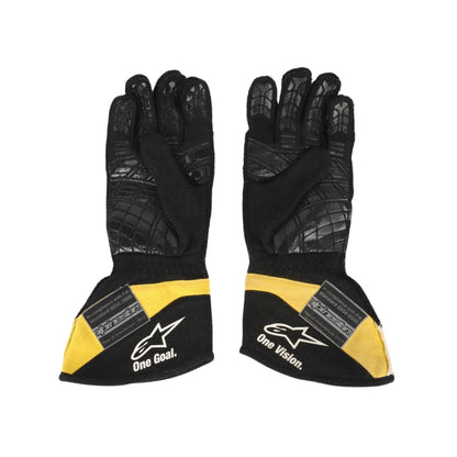 Black and yellow Carlos Sainz 2017 F1 race gloves with branding on a white background