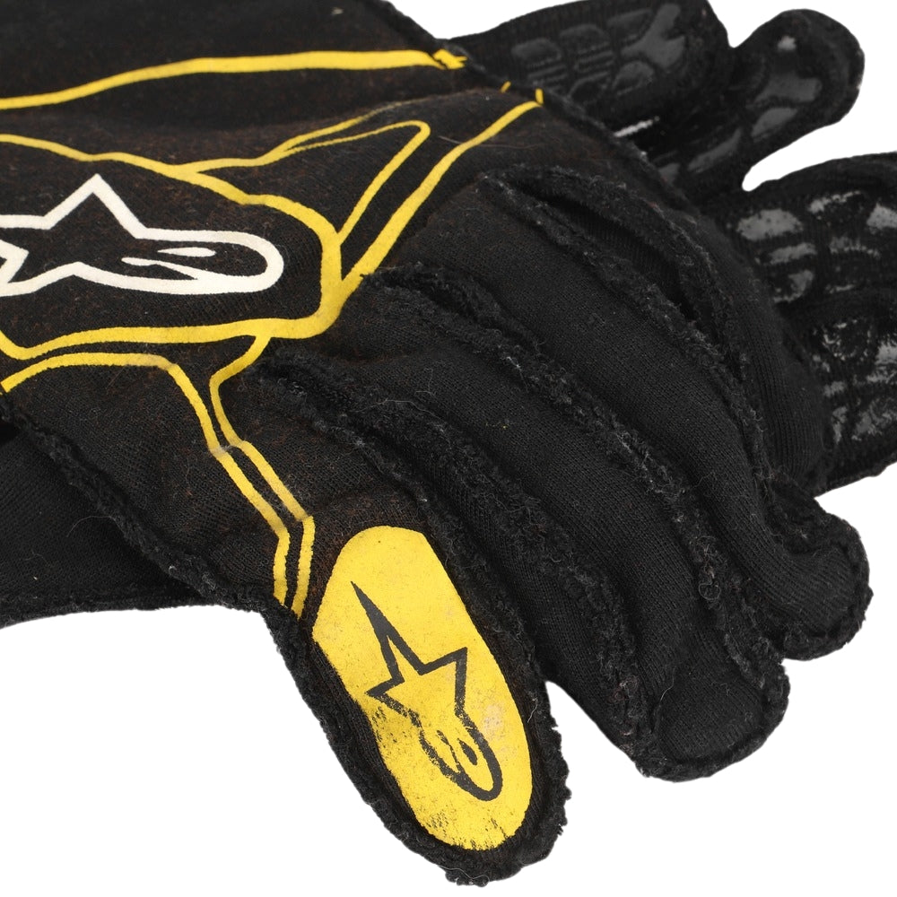 Black Carlos Sainz 2017 F1 Race gloves with yellow accents and a star logo on a white background