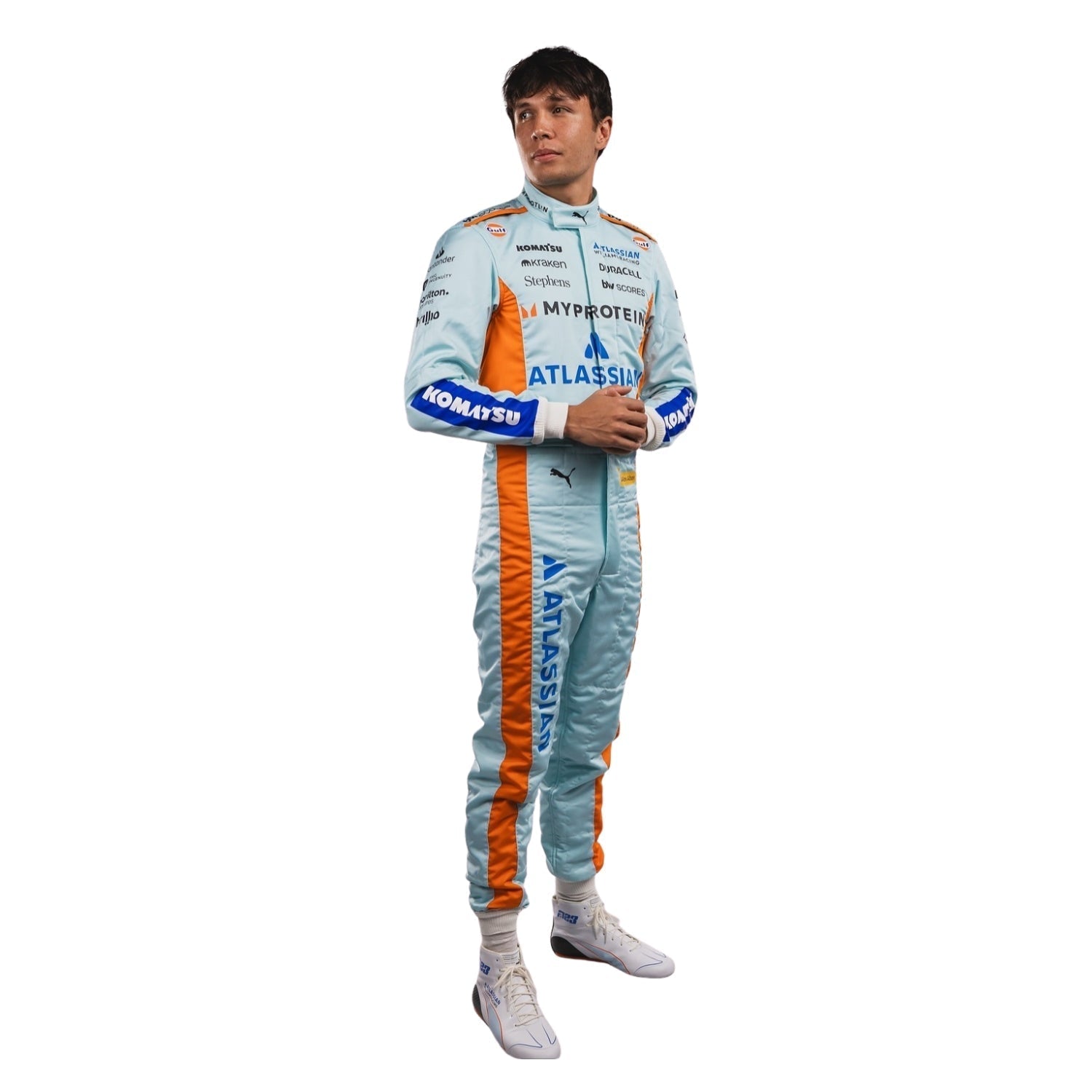 Full View of Alexender wearing a light blue 2025 racing suit with orange accents on a white background