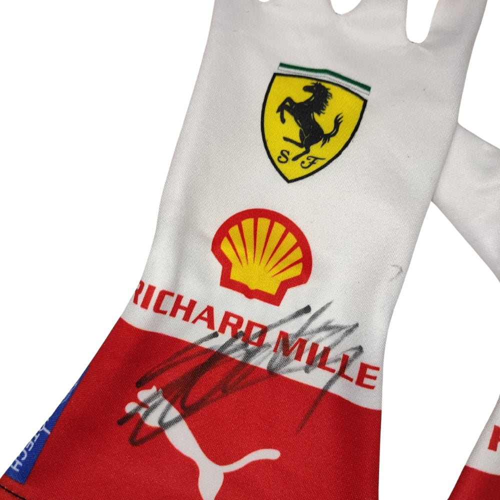Close-up of a Charles Leclerc 2023 Monaco GP F1 Race glove with Ferrari, Shell, and Richard Mille logos on a white background.