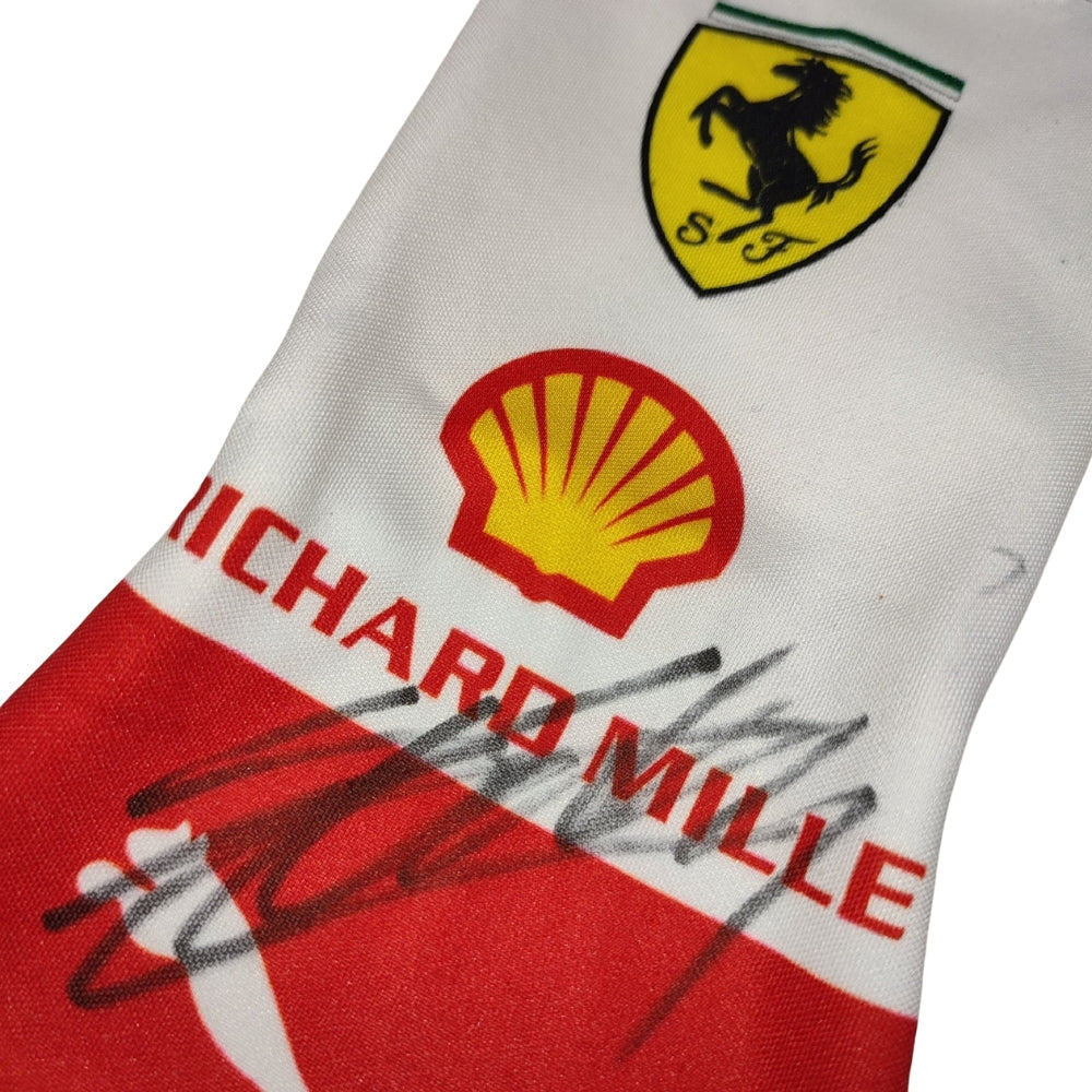 Close-up of a Charles Leclerc 2023 Monaco GP F1 Race Gloves fabric with Ferrari, Shell, and Richard Mille logos.