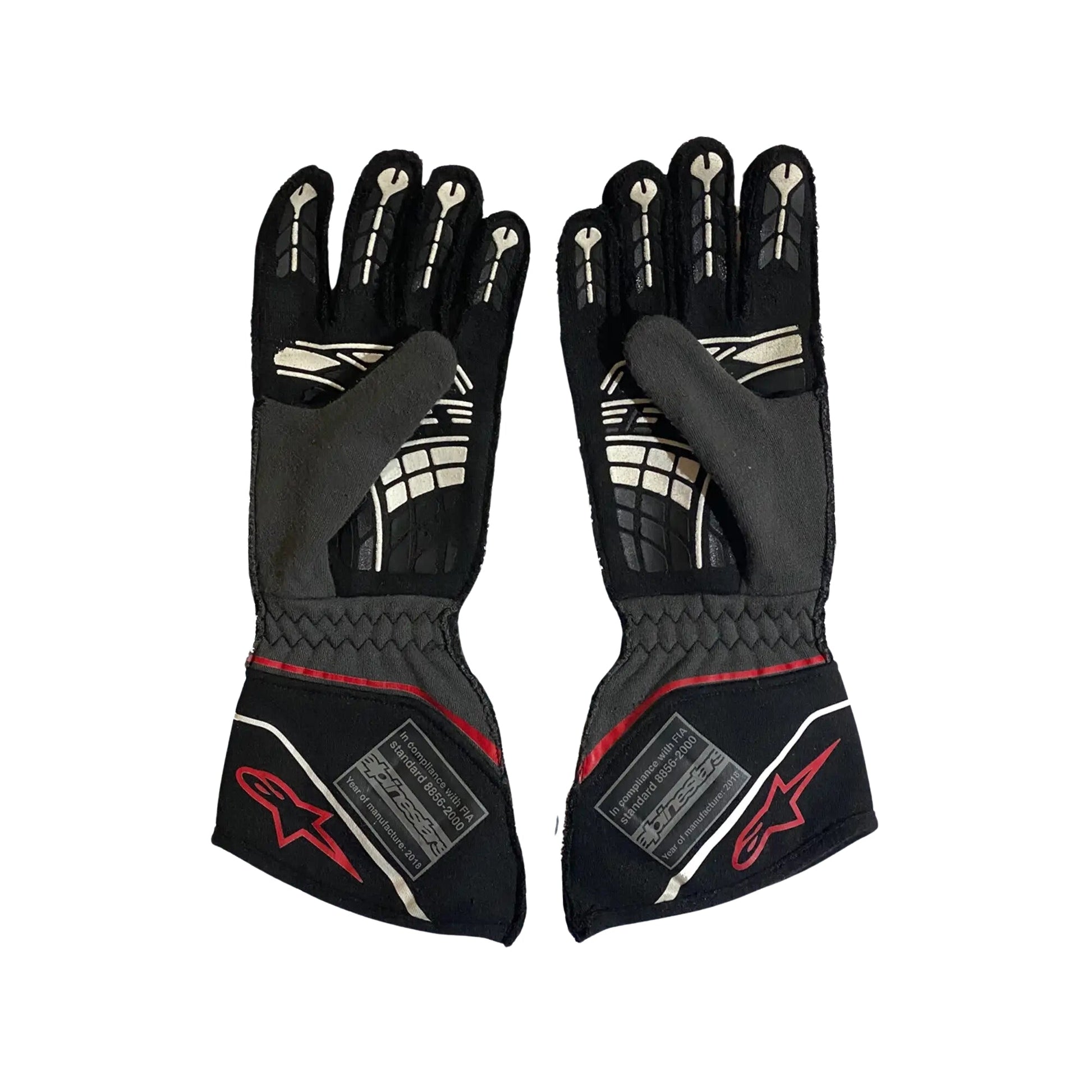 Pair of black Conor Daly 2018 NASCAR race gloves with red accents on a white background