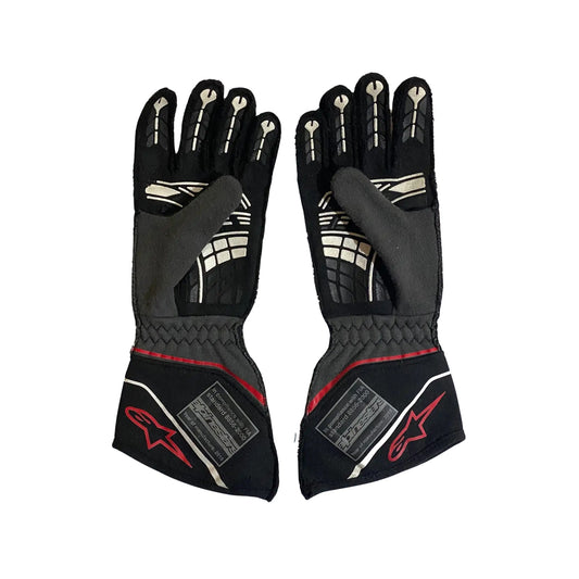 Pair of black Conor Daly 2018 NASCAR race gloves with red accents on a white background