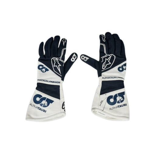 Pair of black and white Daniel Ricciardo 2023 F1 Race gloves with AlphaTauri branding on a white background