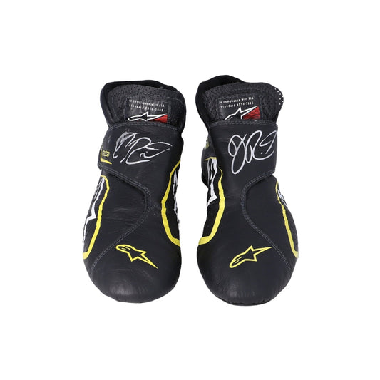 Pair of black and yellow Daniel Ricciardo 2019 Race Worn F1 racing boots with branding on a white background