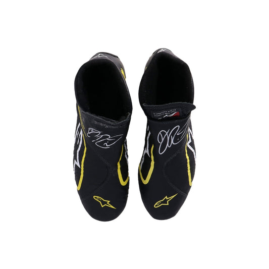 Black Daniel Ricciardo 2019 Race Worn F1 racing shoes with yellow accents on a white background
