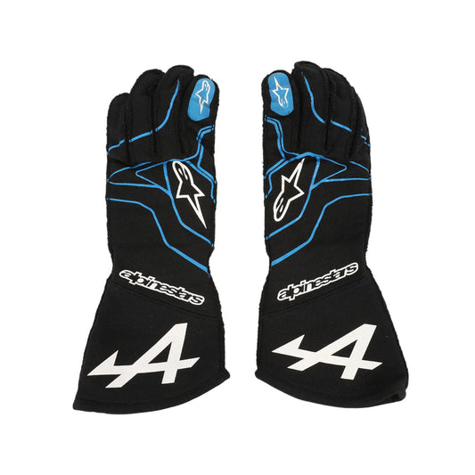 Pair of black Esteban Ocon 2021 F1 race gloves with blue accents and an Alpinestars logo on a white background