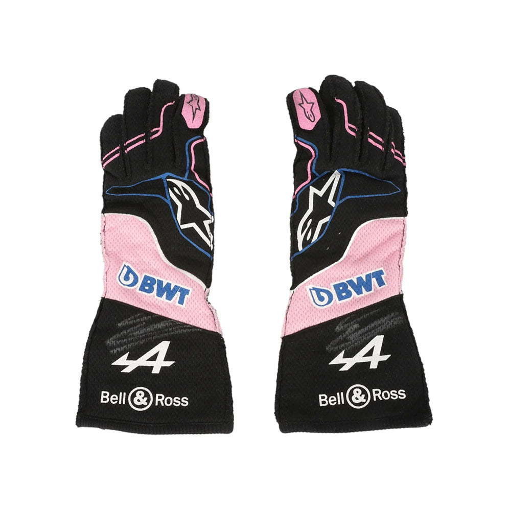 Pair of black and pink Esteban Ocon 2023 Miami GP F1 Race gloves with branding on a white background