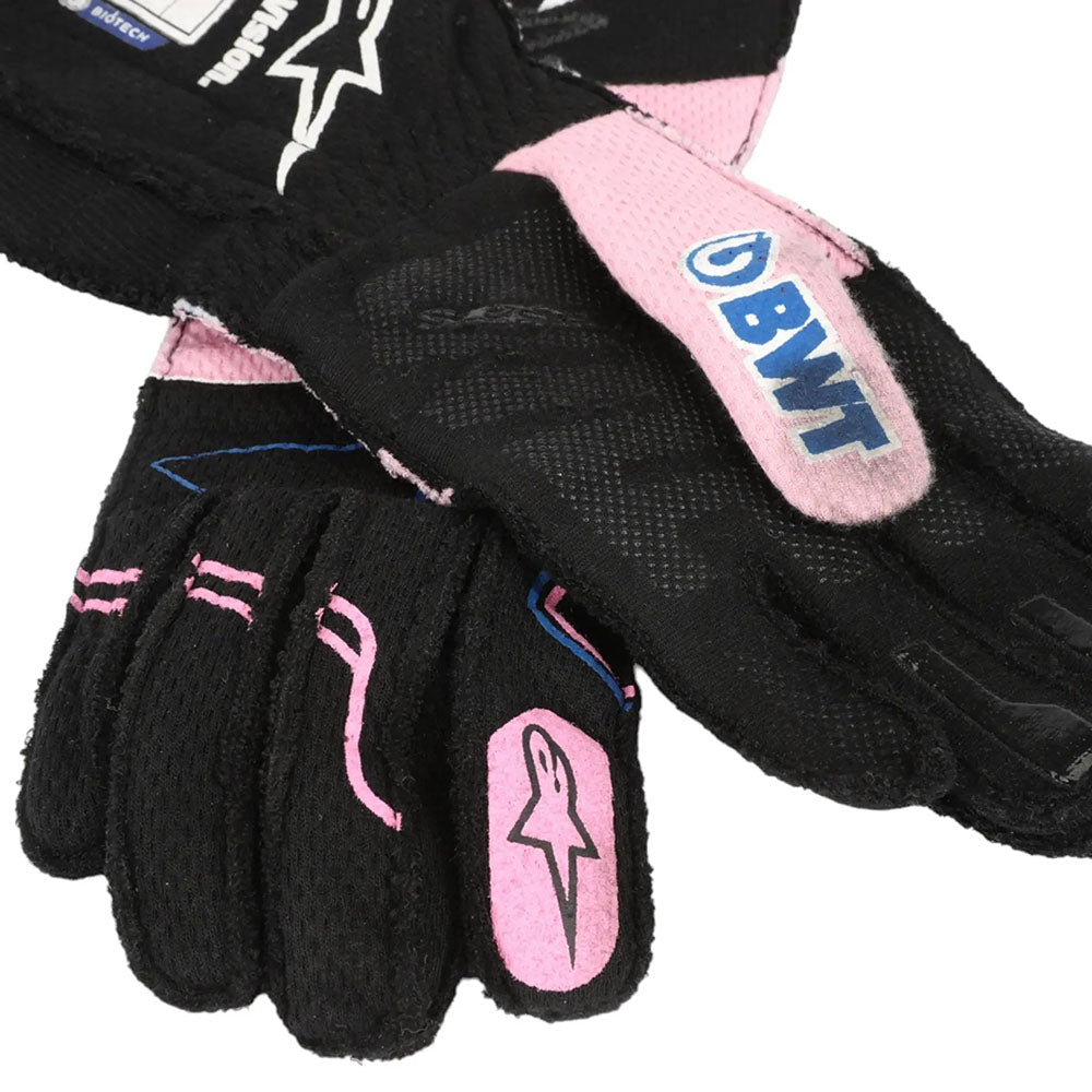Black and pink Esteban Ocon 2023 Miami GP F1 Race gloves with visible branding on a white background