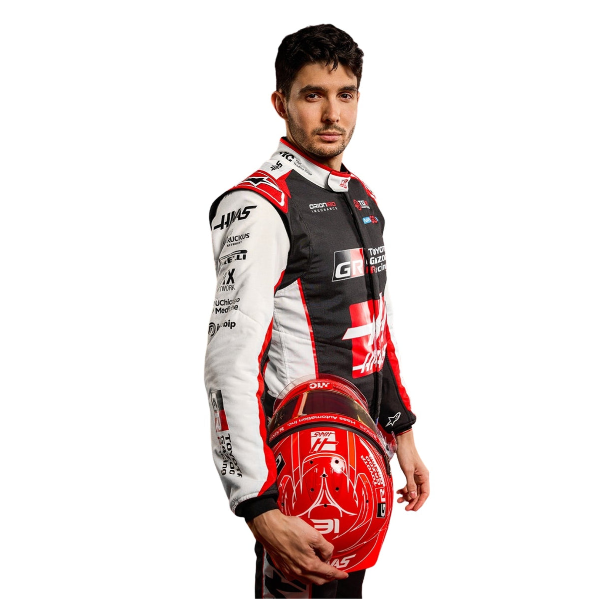 Esteban Ocon wearing a Haas racing suit with various sponsor logos with Close View