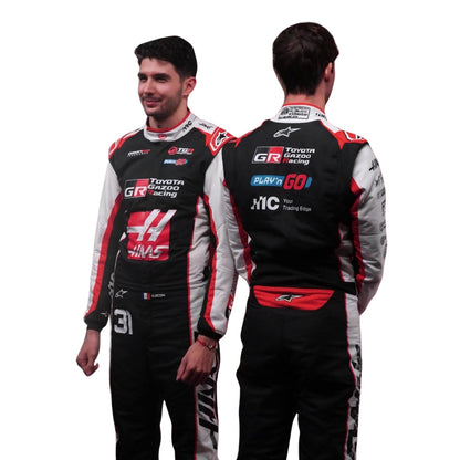 Esteban Ocon wearing a Haas racing suit with various sponsor logos with Close View