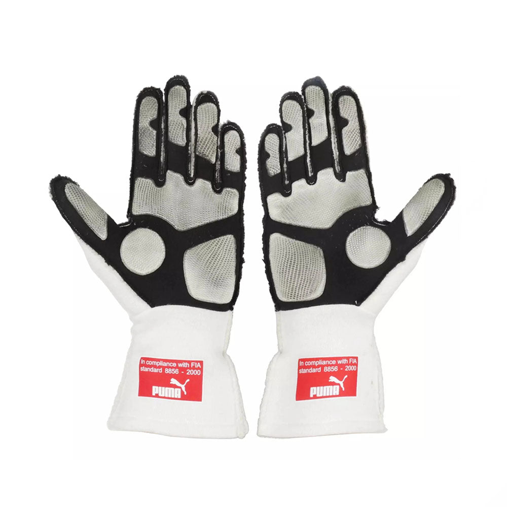 Pair of white and black Fernando Alonso 2010 Japanese GP F1 race gloves with Puma branding on a white background