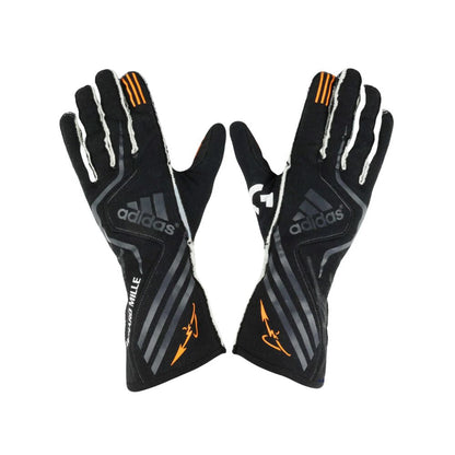 Pair of black Adidas Fernando Alonso 2017 F1 Race gloves with orange accents on a white background