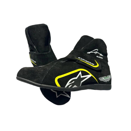 Black Fernando Alonso Aston Martin 2023 F1 racing boots with yellow accents on a white background