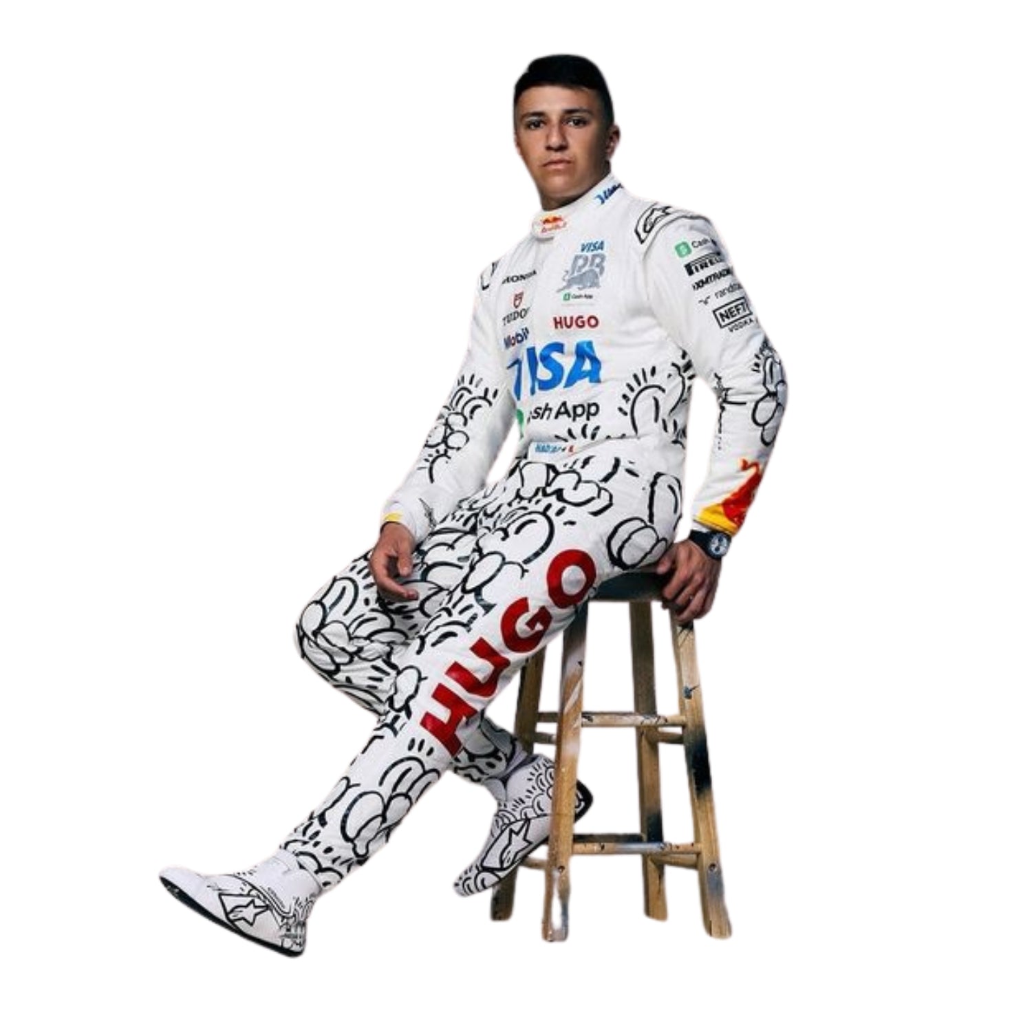 Isack wearing a 2025 british gp white racing suit with various logos sitting on a wooden stool.