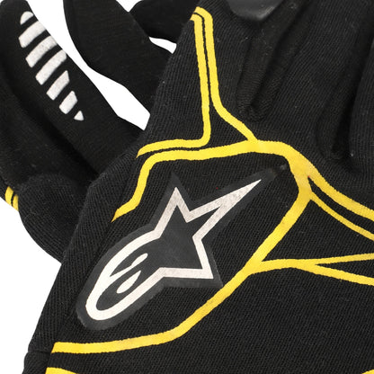 Kevin Magnussen 2016 Black F1 Race glove with yellow accents and a star logo on a white background
