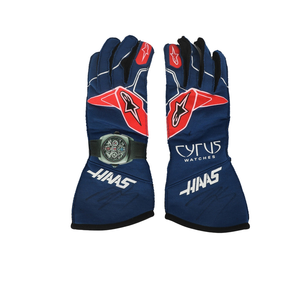 Pair of blue Kevin Magnussen 2022 F1 race gloves with red and white accents on a white background