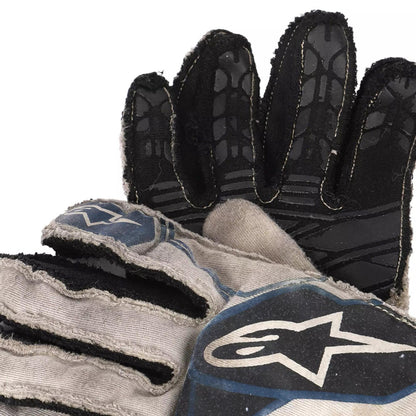 Close-up of a black and gray Lance Stroll 2017 F1 Race glove with a brand logo on a white background