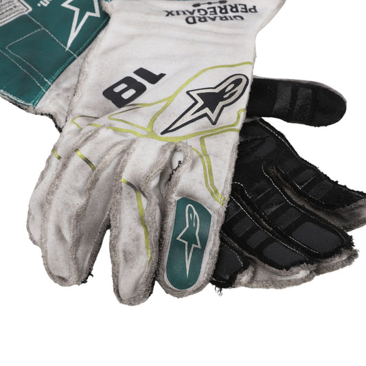 Close-up of a Lance Stroll 2022 Dutch GP white and black F1 race gloves with branding on a white background