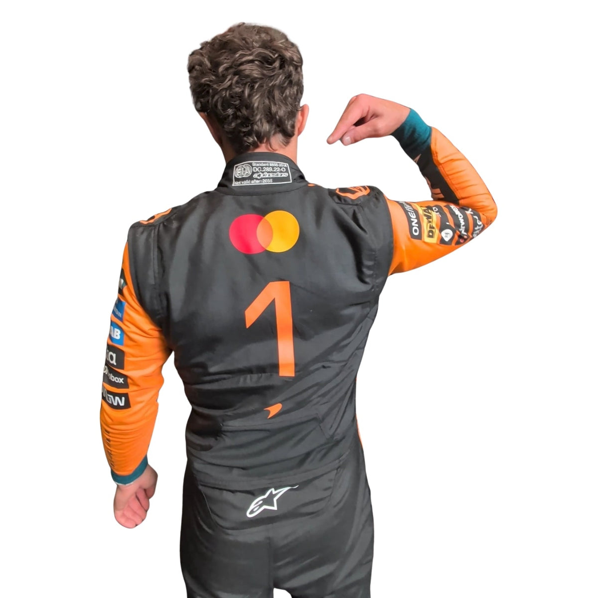 Lando Norris wearing a McLaren racing suit with various sponsor logos with Close View