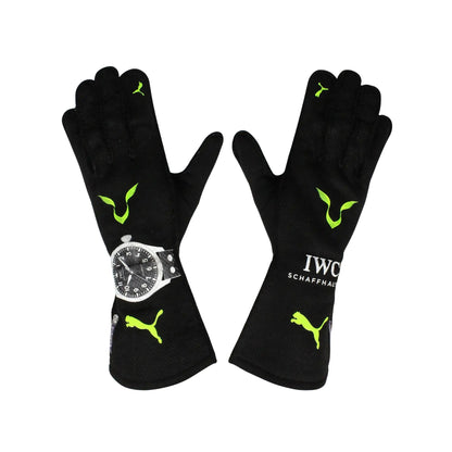 Black Lewis Hamilton 2022 F1 Race gloves with green accents and a watch on a white background