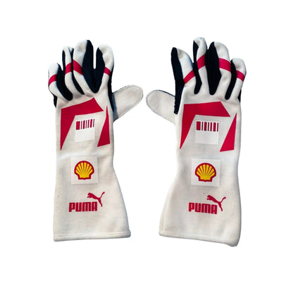 Pair of white Michael Schumacher 2007 F1 race gloves with red and black accents featuring Puma and Shell logos on a white background.