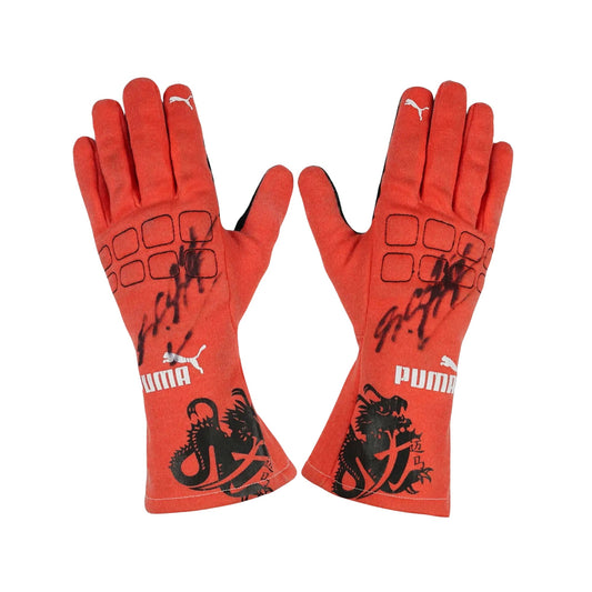 Red Michael Schumacher 2012 F1 Race gloves with black designs and Puma logo on a white background