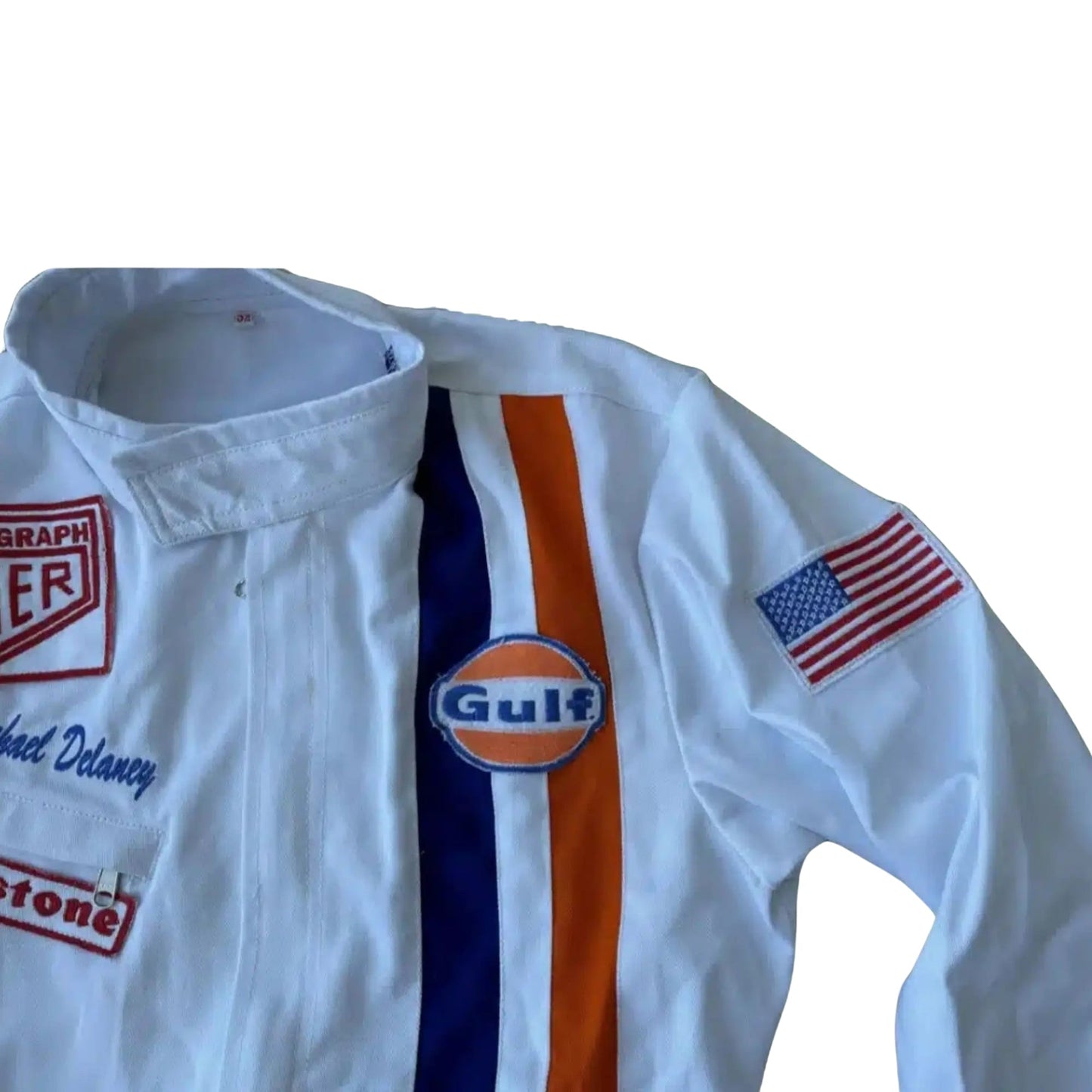Close-up of the Gulf and Heuer logo patches, stitching detail, and authentic period-correct fabric from the 1971 Le Mans suit worn by Steve McQueen.