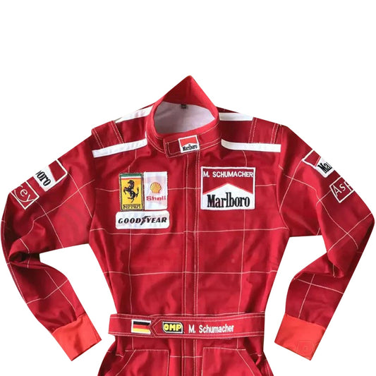 Close-up of Schumacher’s 1996 F1 suit, featuring the detailed stitching, Ferrari red color, and early sponsor branding from his debut season