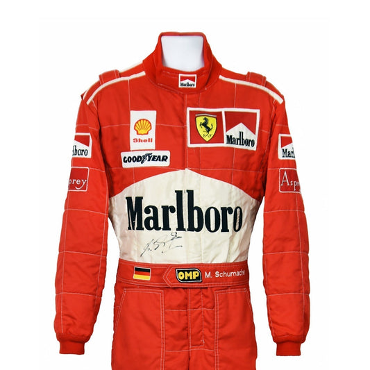 Close-up of Schumacher’s 1997 F1 race suit, displaying detailed stitching and rich red fabric, with sponsor logos highlighting his drive during the 1997 season.