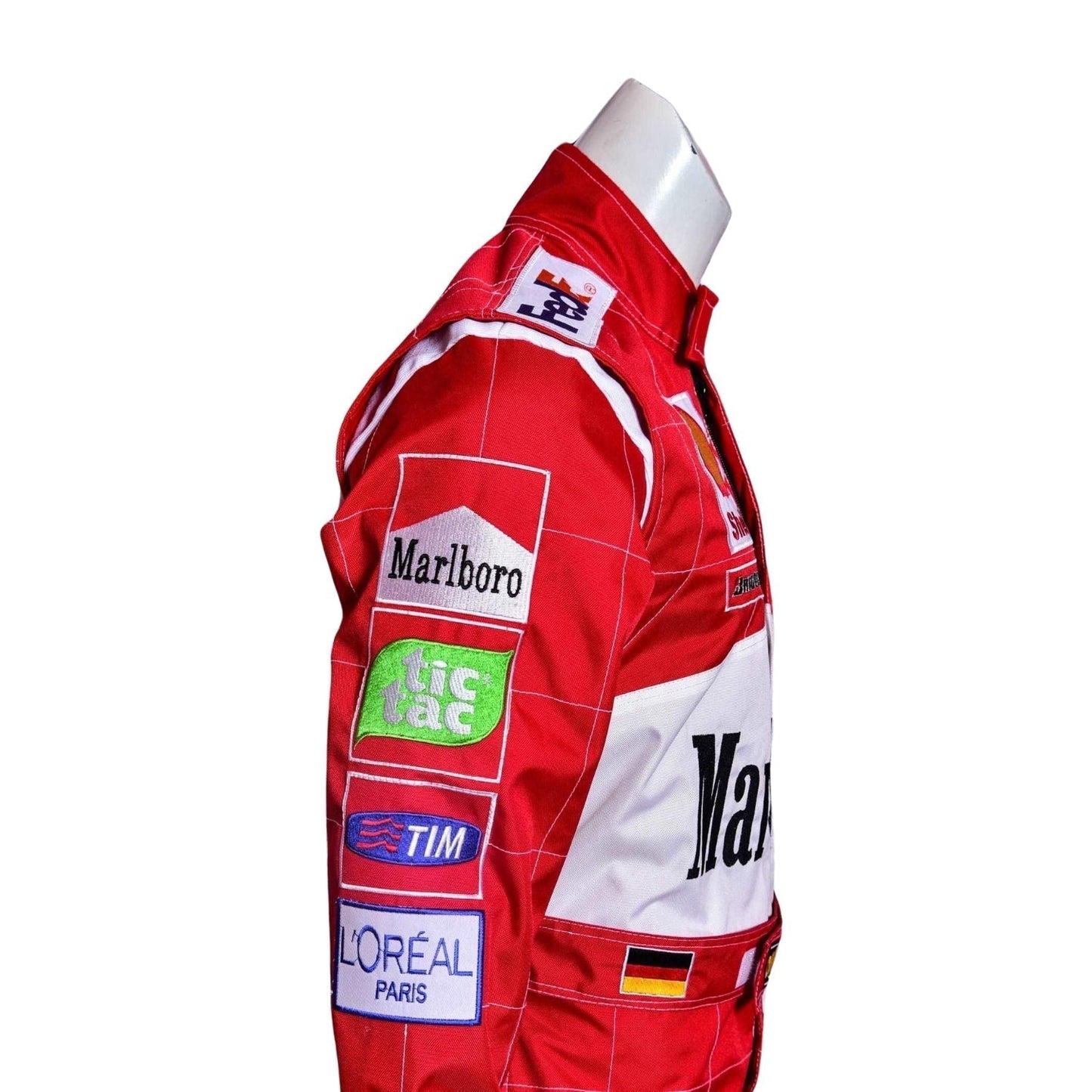 Side profile of Schumacher’s 2000 racing suit, displaying Ferrari red and clean white stripes along the torso with sponsor logos from his dominant 2000 season.