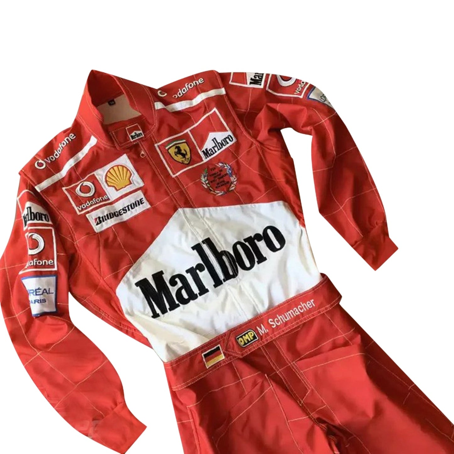 Close-up of the 2005 Schumacher suit highlighting fine embroidery, Ferrari red color tone, and precise stitching on race-worn sponsor badges.