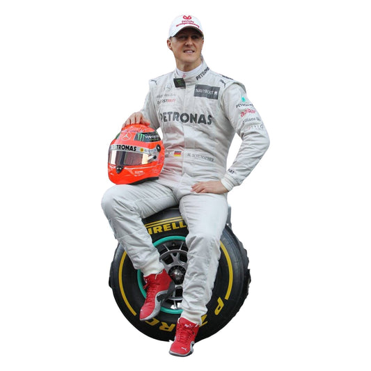 Front view of the 2012 Michael Schumacher F1 racing suit, featuring a silver base with black and green accents, and stitched sponsor panels across the chest.