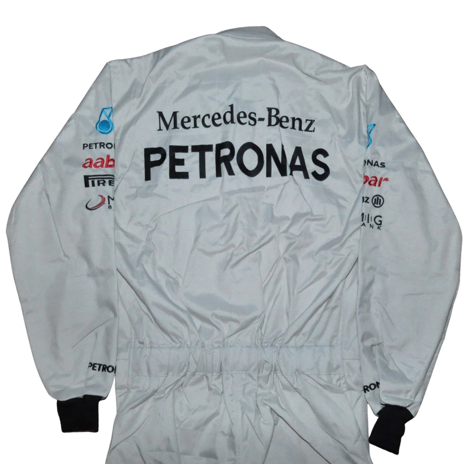 Back view of Schumacher’s 2012 F1 suit showing full-length silver material with contrasting black paneling and his signature logo on the upper back.