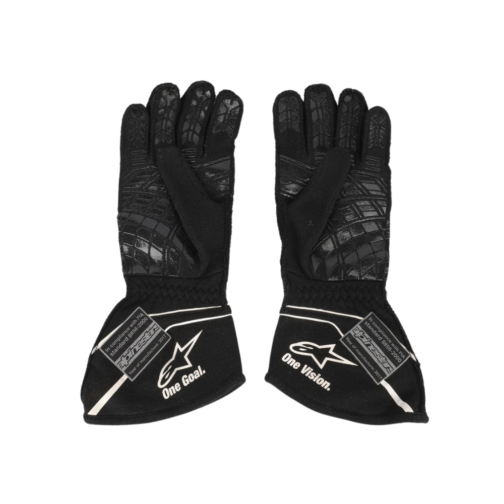 Pair of black Nico Hülkenberg 2017 F1 race gloves with visible branding on a white background