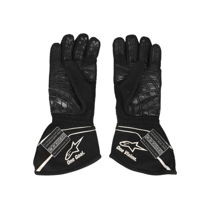Pair of black Nico Hülkenberg 2017 F1 race gloves with visible branding on a white background