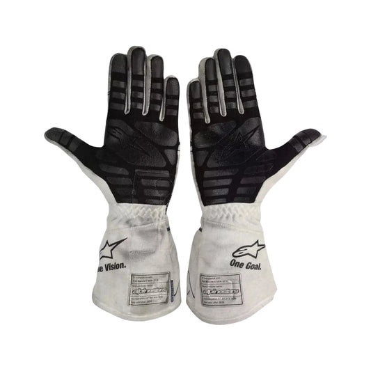 Pair of black and white Pierre Gasly 2020 F1 race gloves with visible branding on a white background