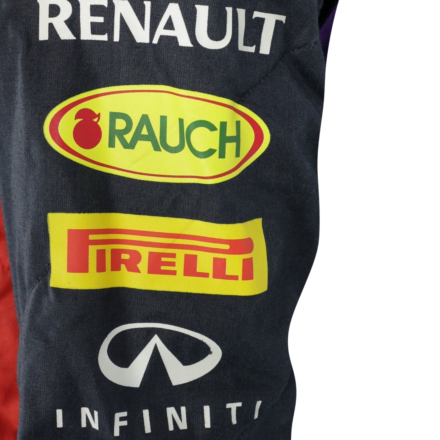 Close-up of Sebastian Vettel’s 2014 racing suit fabric, showing deep blue color combined with red and yellow sponsor logos and stitching.