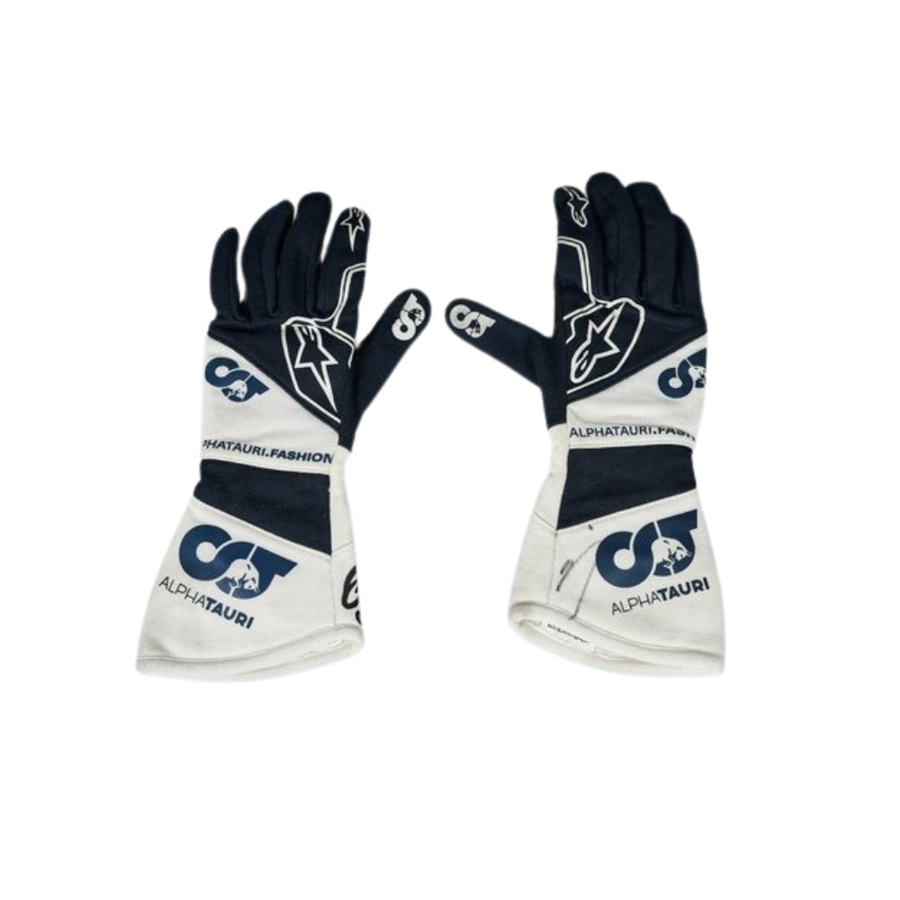 Pair of black and white Yuki Tsunoda 2022 F1 Race gloves with branding on a white background