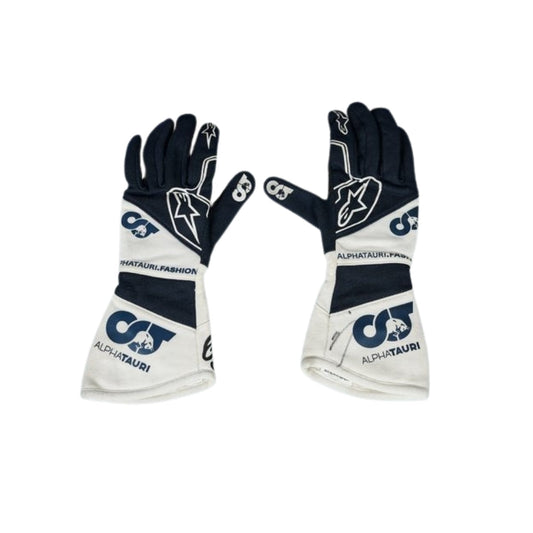 Pair of black and white Yuki Tsunoda 2022 F1 Race gloves with branding on a white background