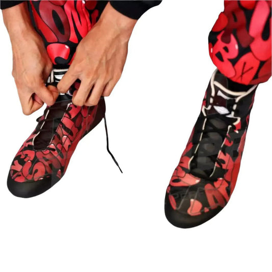 Red and black patterned Zhou Guanyu 2023 Special Edition F1 Race shoes are being worn on a white background