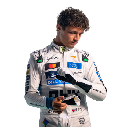 Lando Norris wearing a white racing suit with multiple sponsor logos against a plain white background.