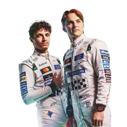 Two Formula 1 drivers in white racing suits with various sponsor logos, standing against a solid white background.