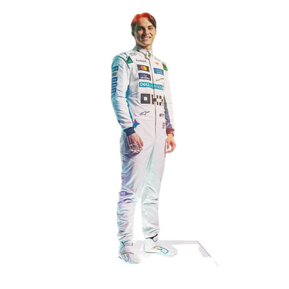 A full-body printed cardboard cutout of a smiling race driver in a white racing suit with colorful sponsor logos, shown against a plain white background.